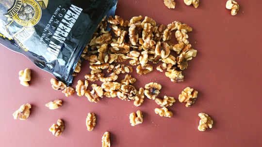 An elegant arrangement of assorted nuts and handcrafted confections in a warm, inviting setting, highlighting Western Nut Company's offerings.